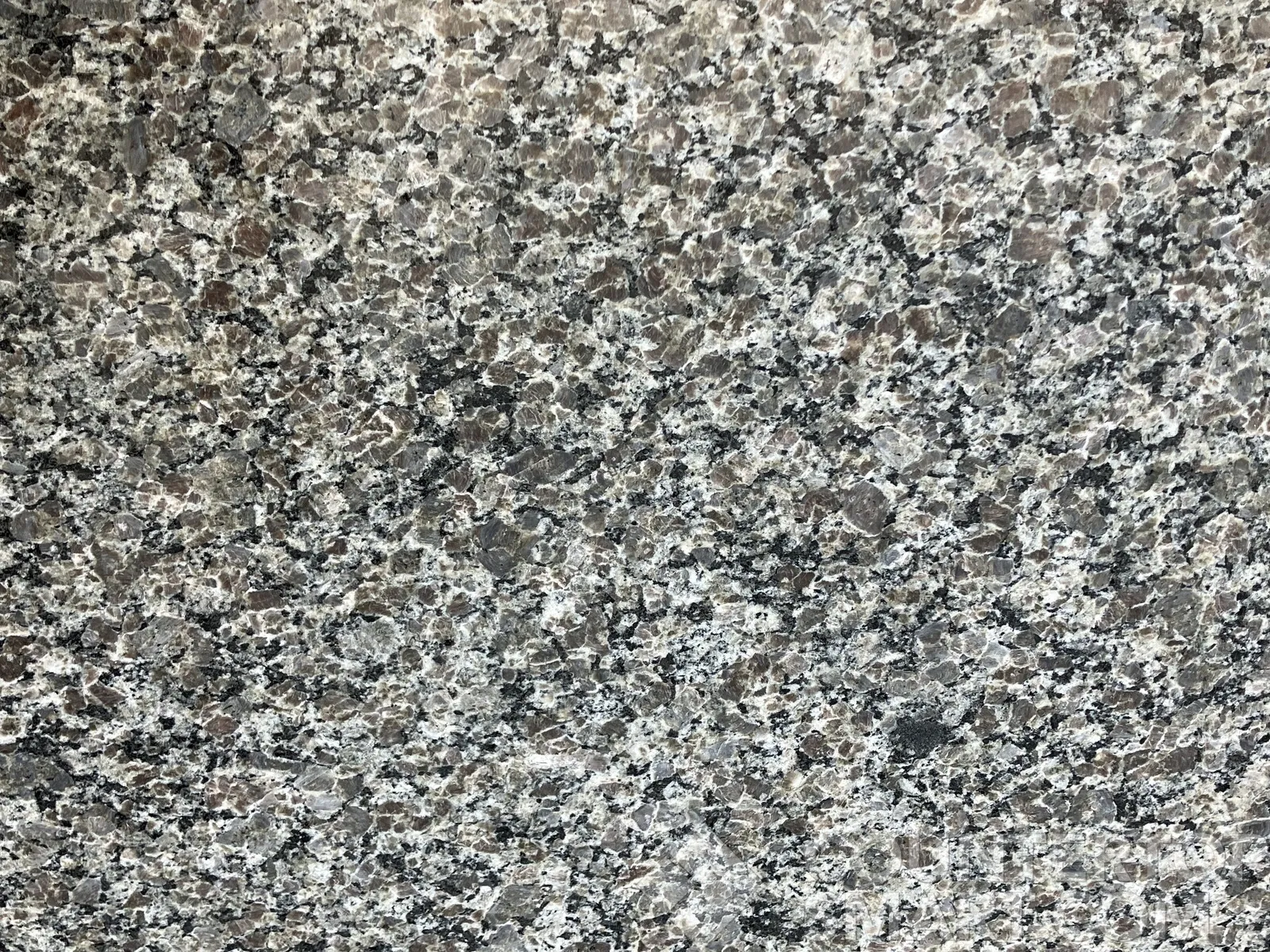 Closeup image of New Caledonia Granite countertop slab