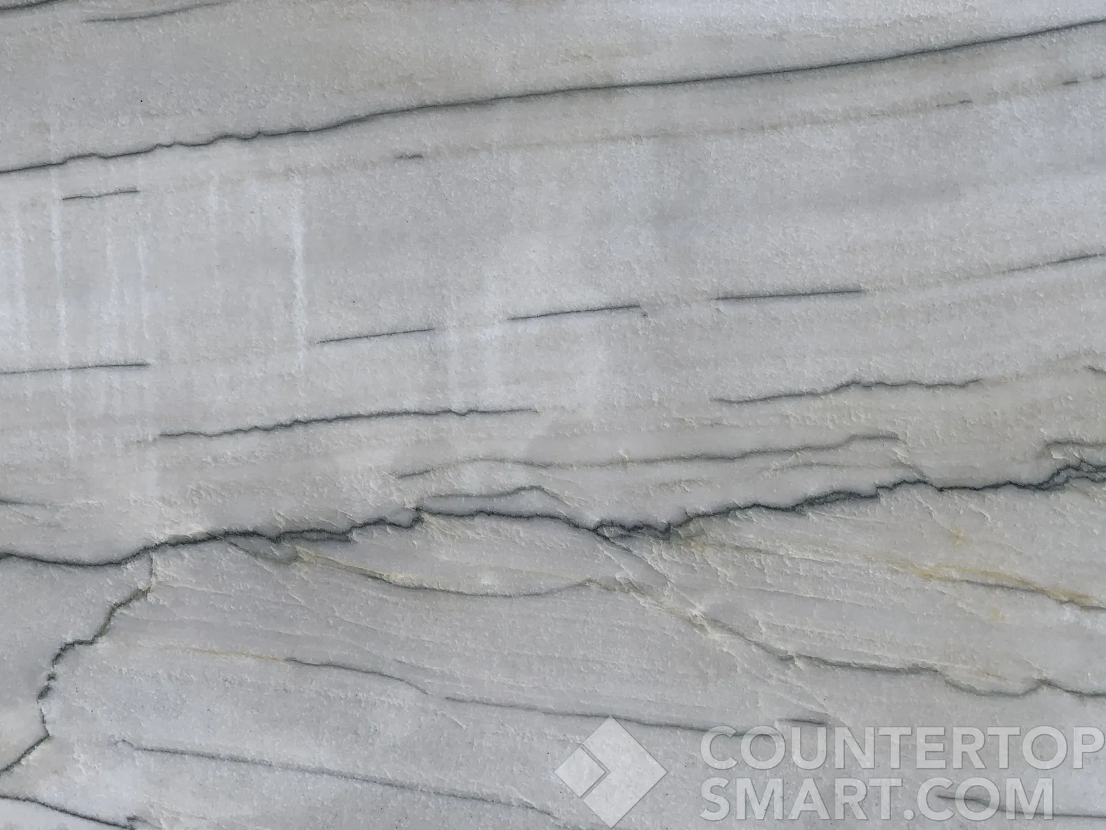 Closeup image of White Macaubas Quartzite countertop slab