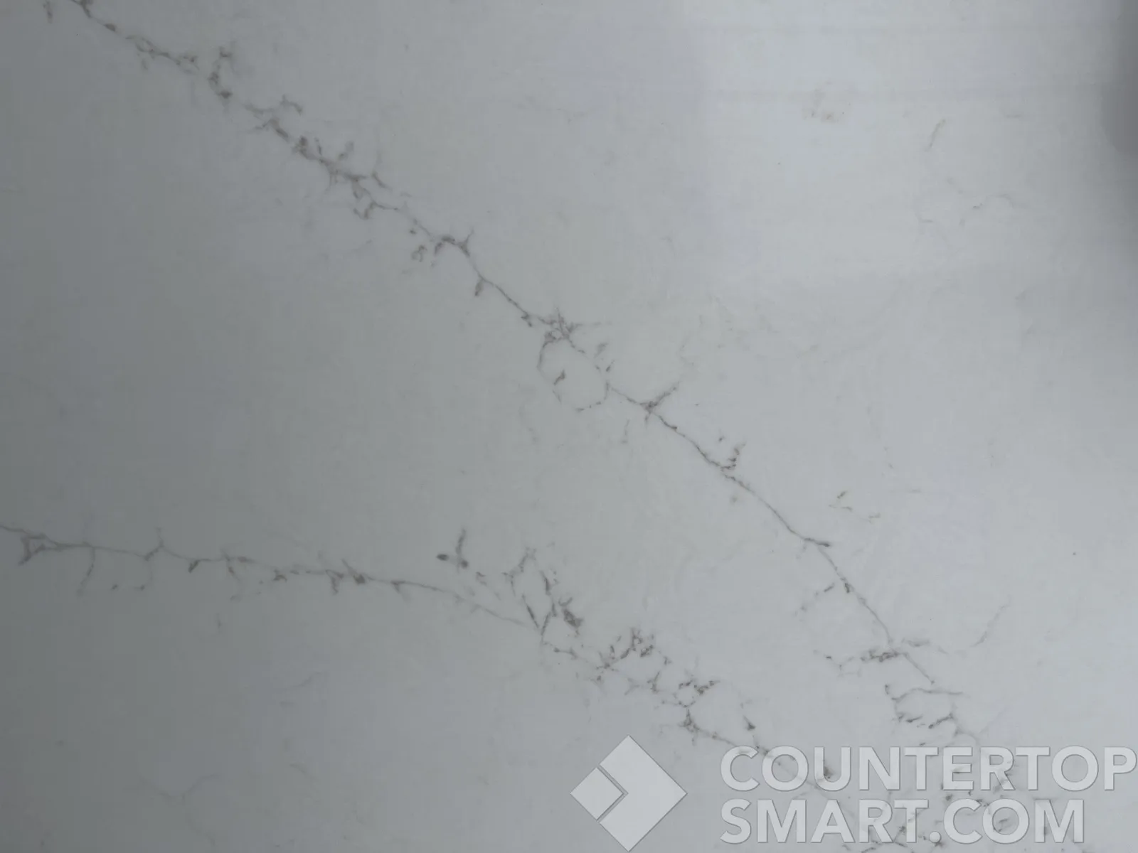 Closeup image of Q Quartz Calacatta Delios Quartz countertop slab