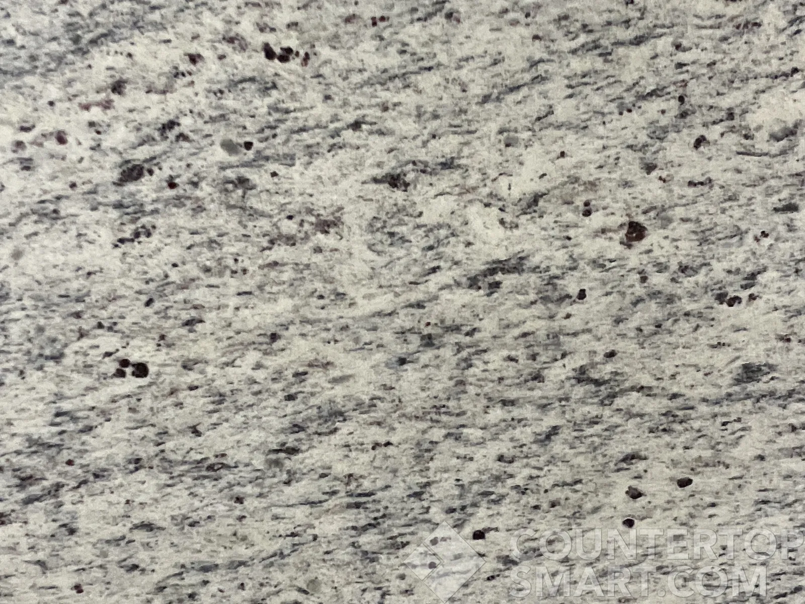 Closeup image of Dallas White Granite countertop slab
