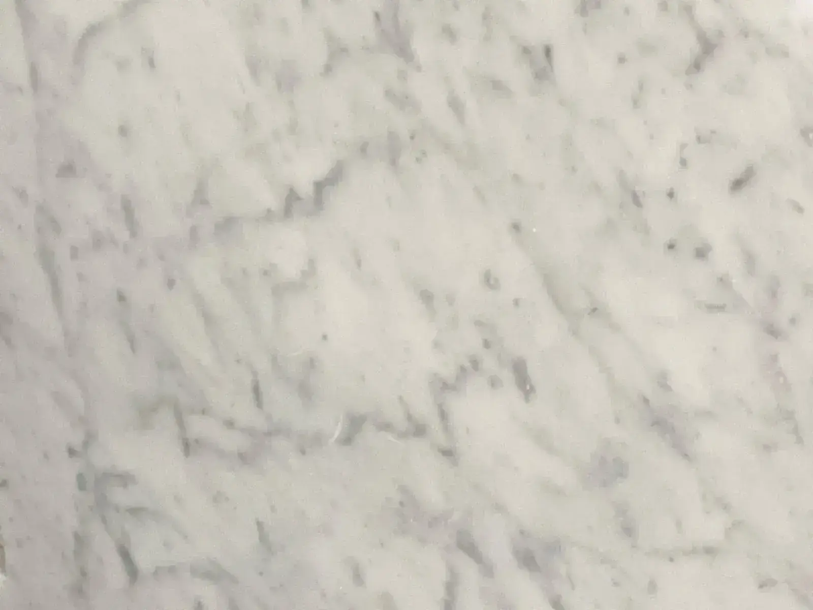Closeup image of Bianco Carrara Marble countertop slab