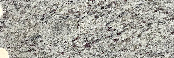 Closeup image of Dallas White Granite countertop slab