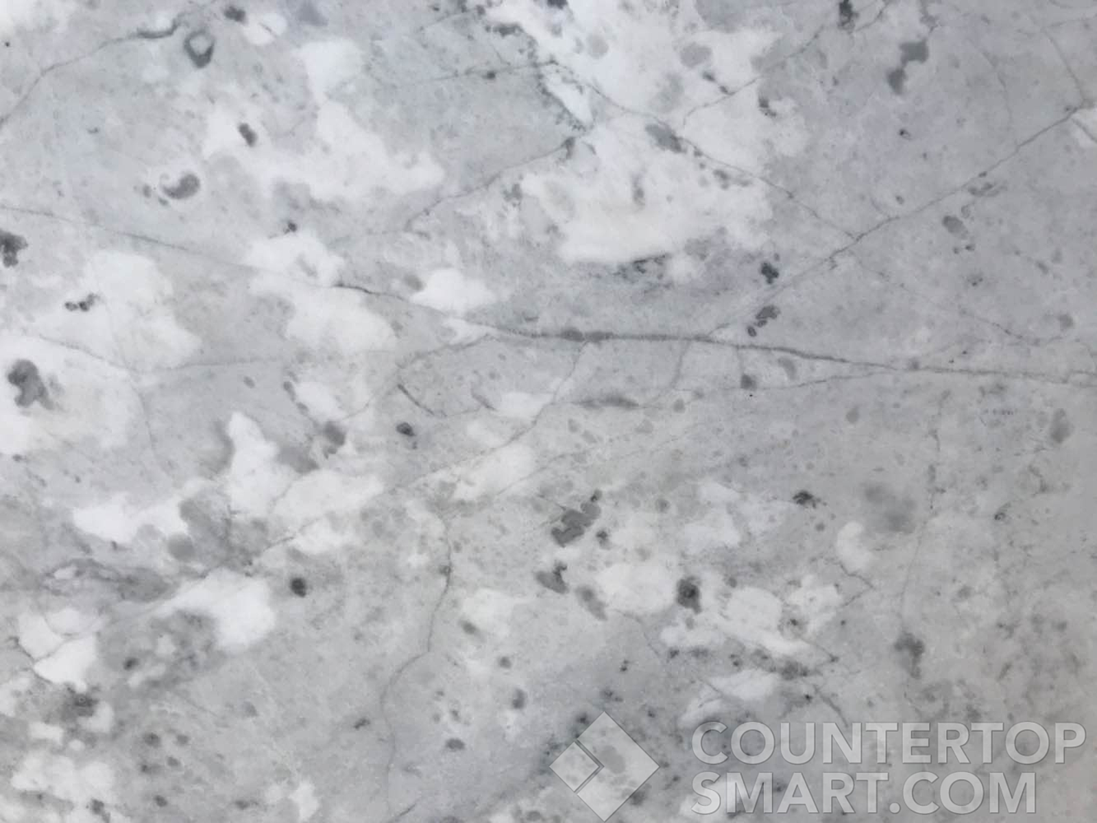 Closeup image of Bianco Carrara Marble countertop slab