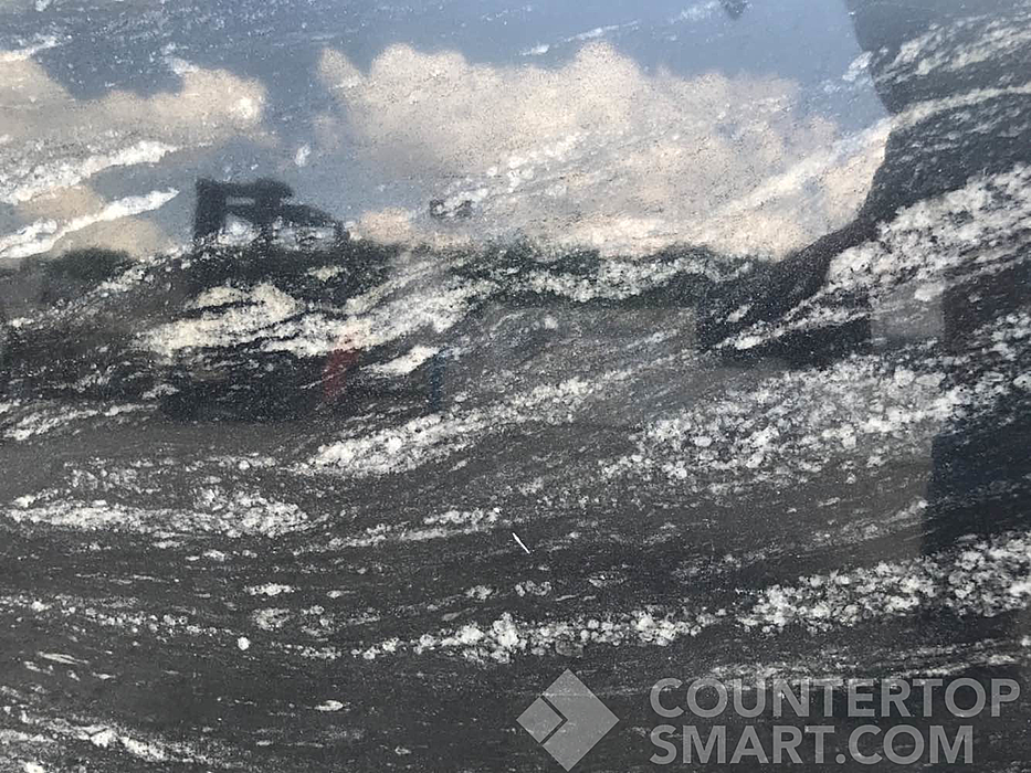 Closeup image of Cosmic Black Granite countertop slab