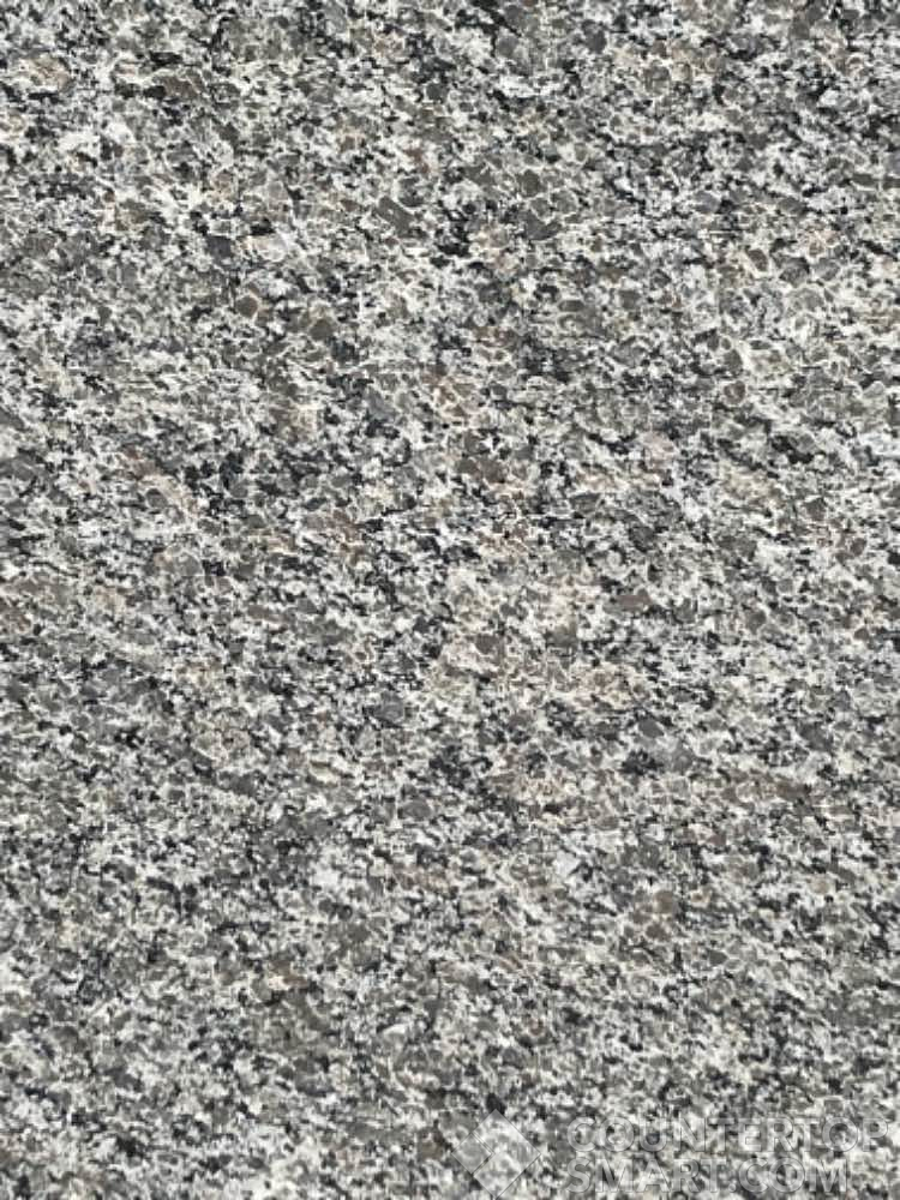 Closeup image of New Caledonia Granite countertop slab
