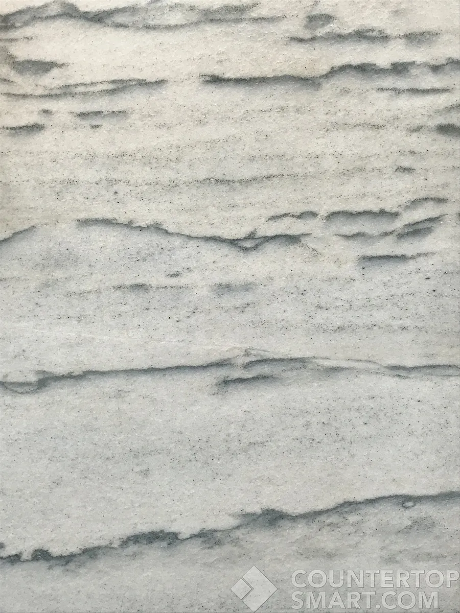 Closeup image of White Macaubas Quartzite countertop slab