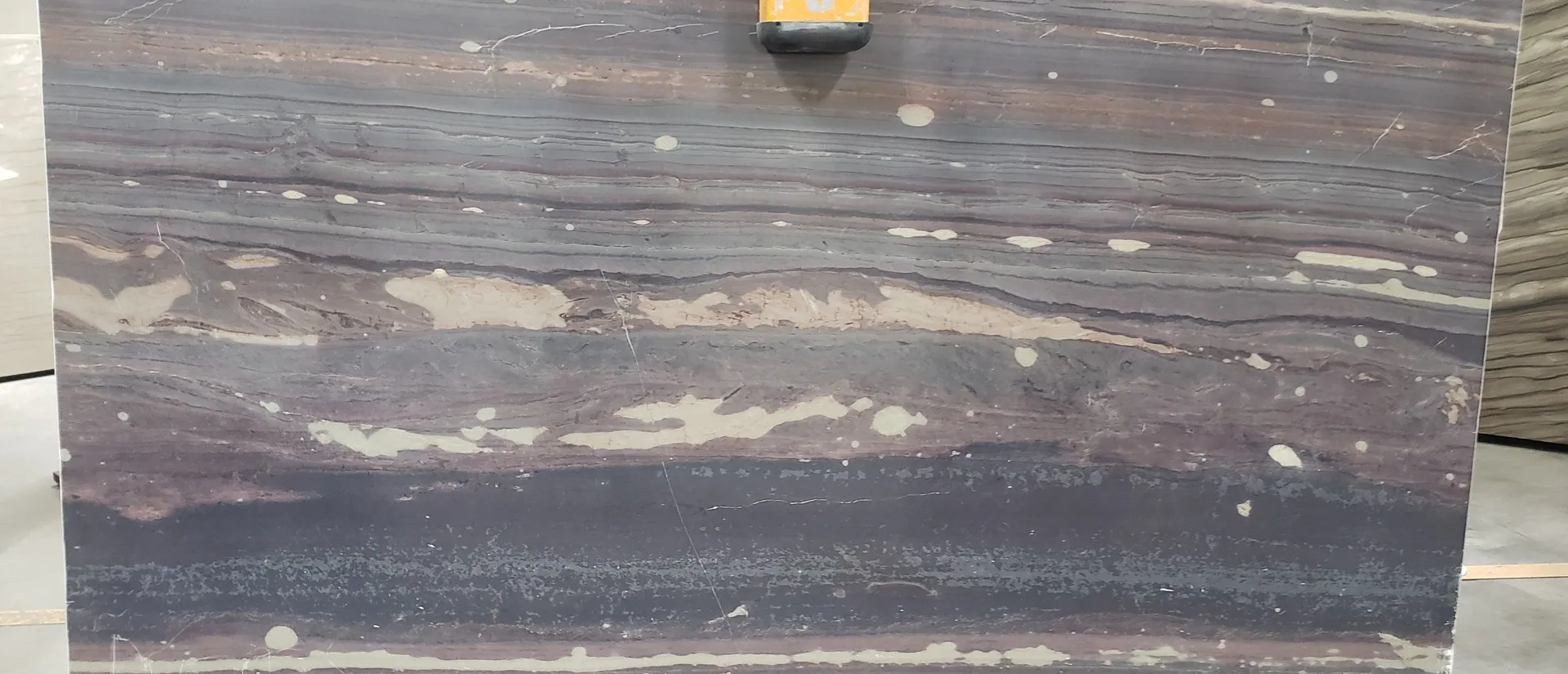 Closeup image of Marron Bamboo Purple Granite countertop slab