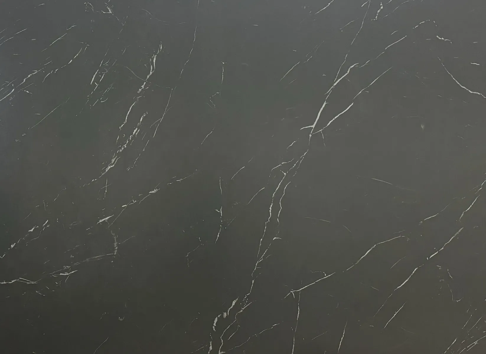 Closeup image of Opal Surfaces Nero Marquina Black Porcelain countertop slab