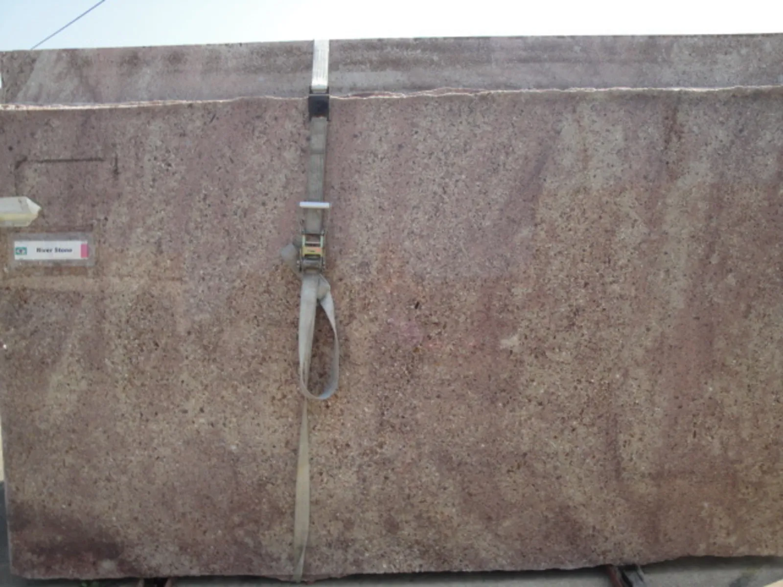 Closeup image of River Stone (Red Montana) Brown Granite countertop slab