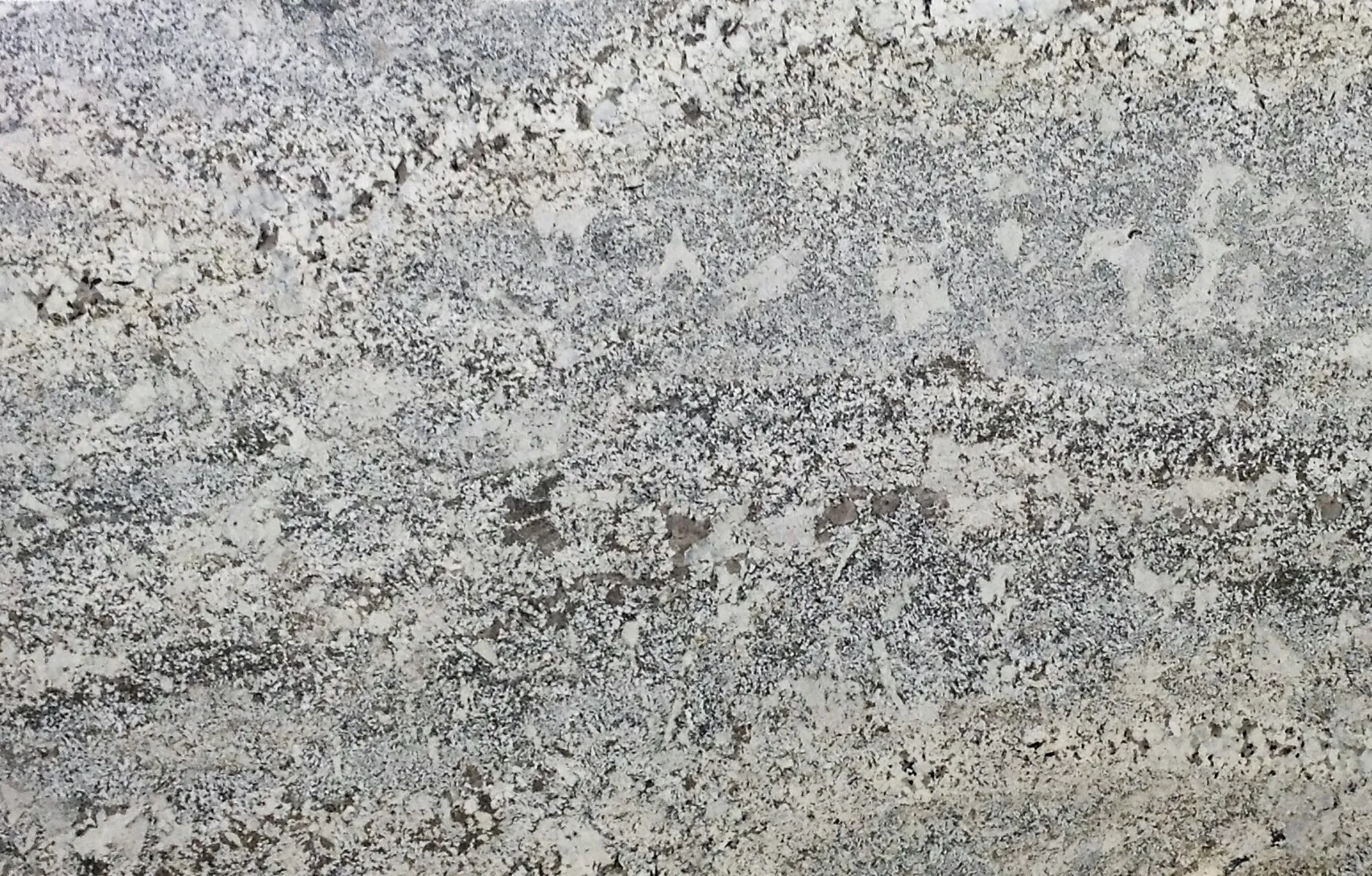 Closeup image of Bianco Typhoon Cream Granite countertop slab