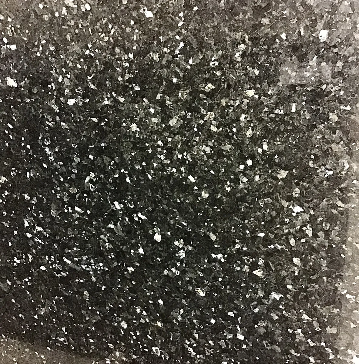 Closeup image of Emerald Pearl Black Granite countertop slab