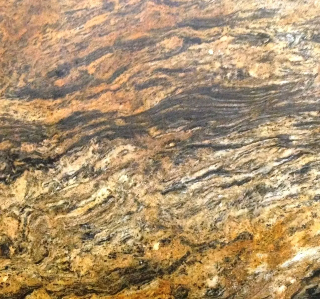 Closeup image of Golden Storm Velvet Brown Granite countertop slab