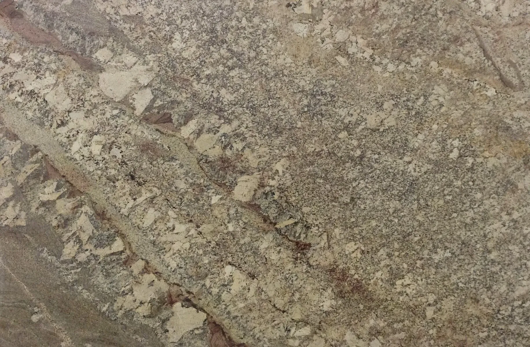 Closeup image of Netuno Bordeaux River Beige Granite countertop slab