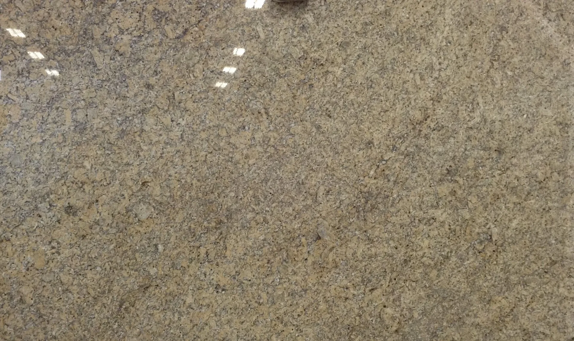 Closeup image of New Venetian (Cristalino Gold) Beige Granite countertop slab