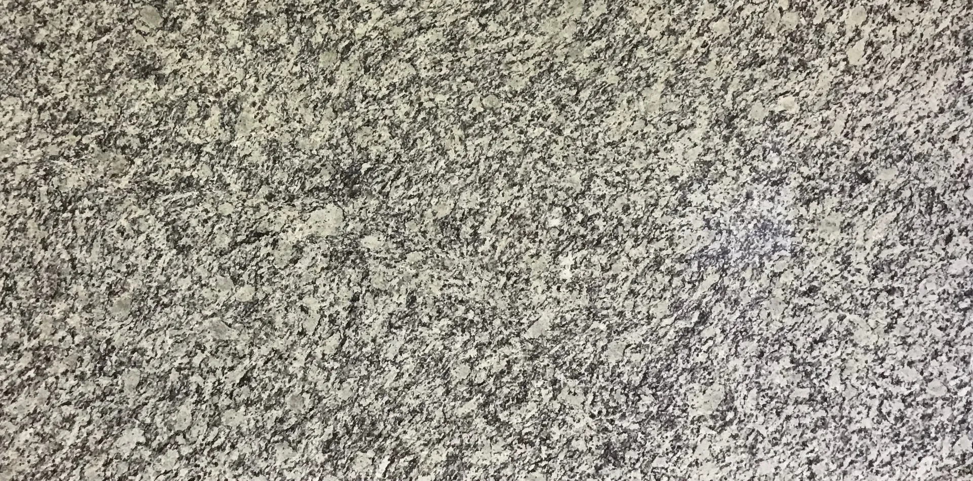 Closeup image of Opereta Cream Grey Granite countertop slab