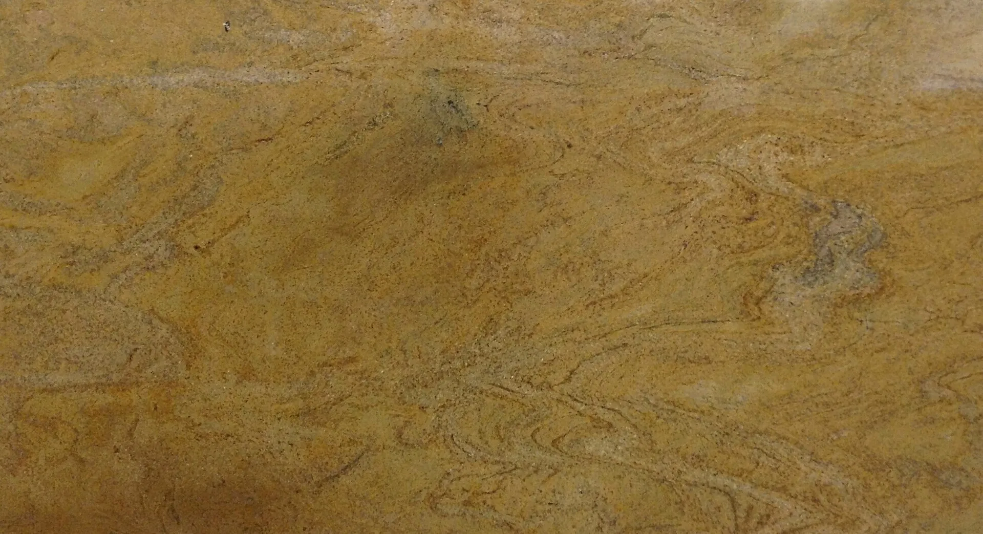 Closeup image of Sahara Gold Yellow-Gold Granite countertop slab