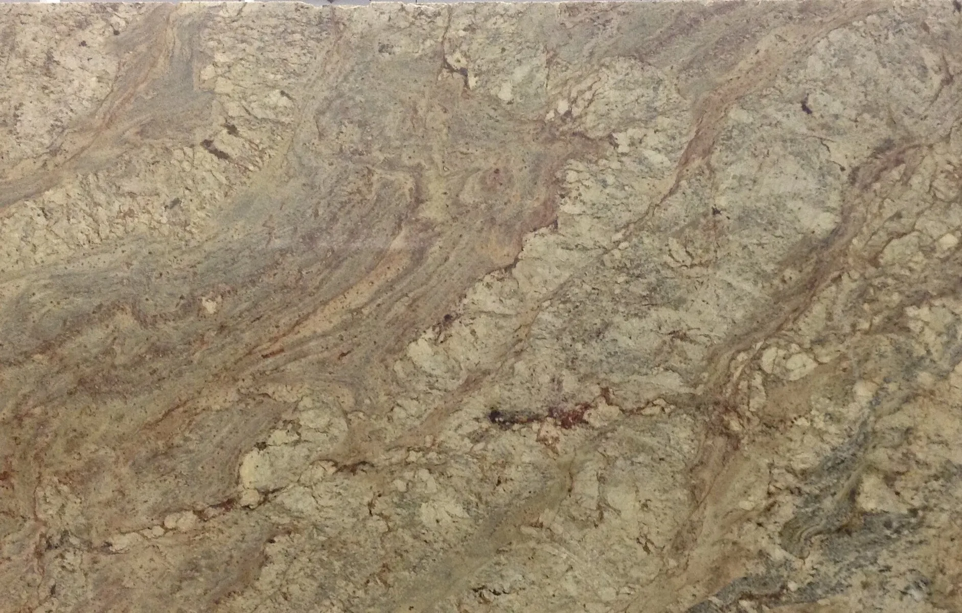 Closeup image of Typhoon Bordeaux Beige Granite countertop slab