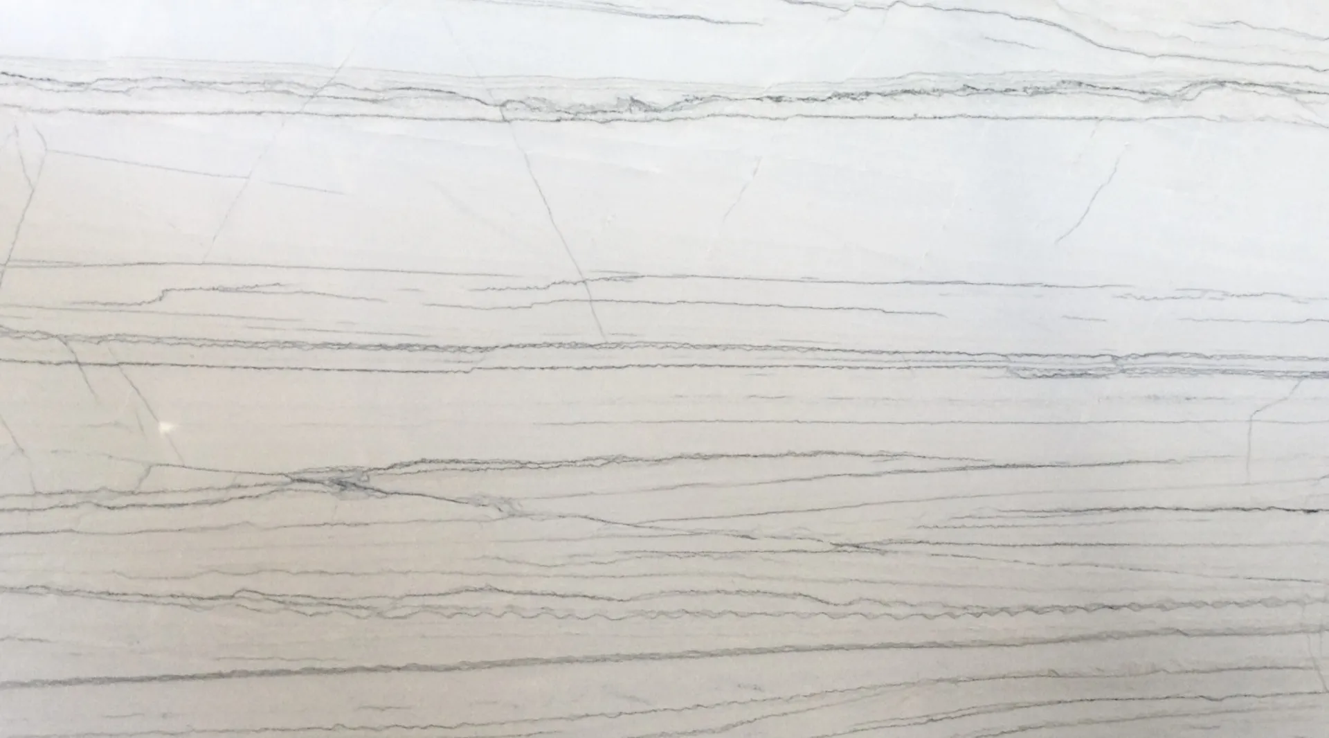 Closeup image of White Macaubas Cream Quartzite countertop slab