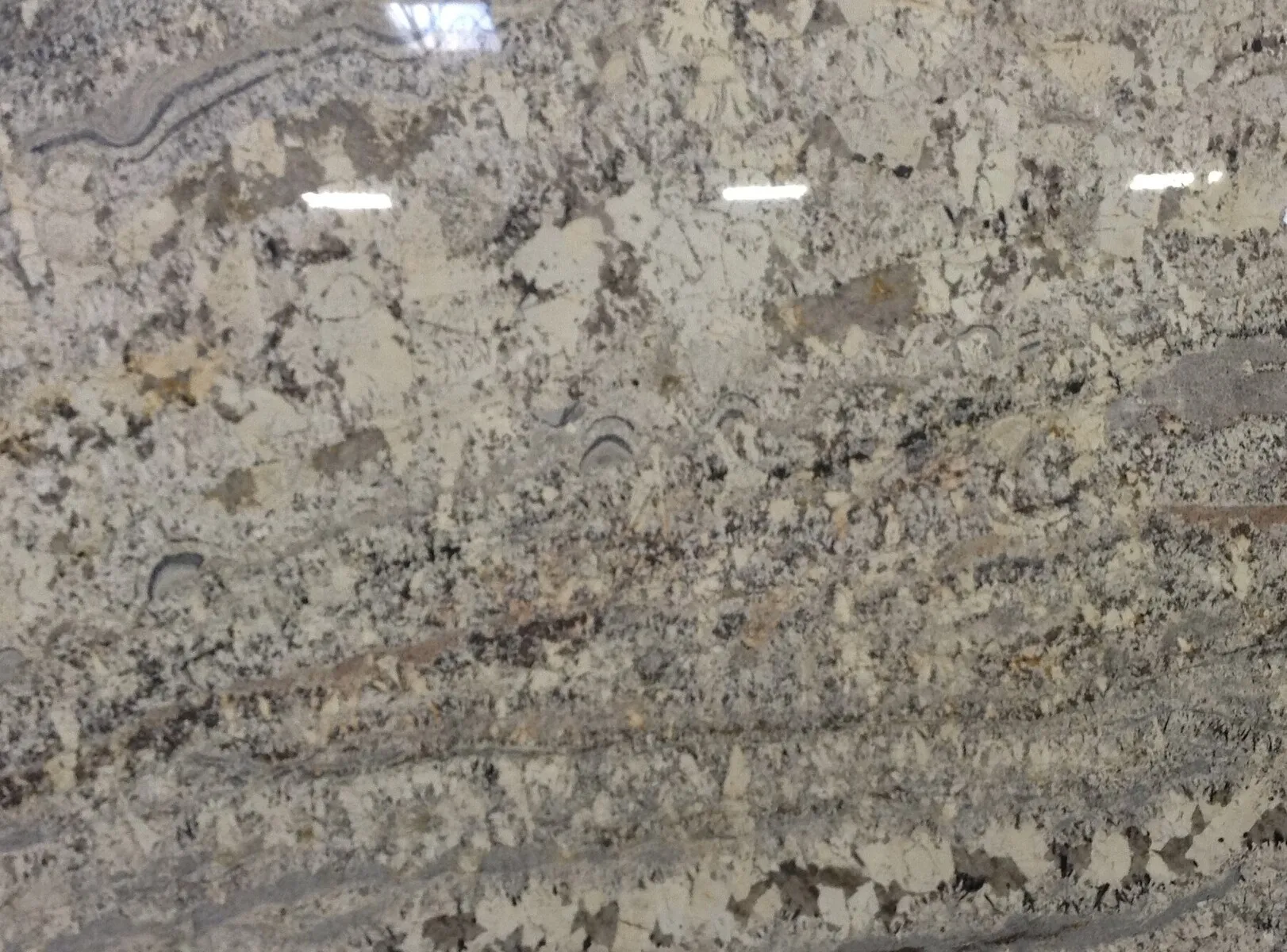 Closeup image of White Persa (Springs) Cream Granite countertop slab