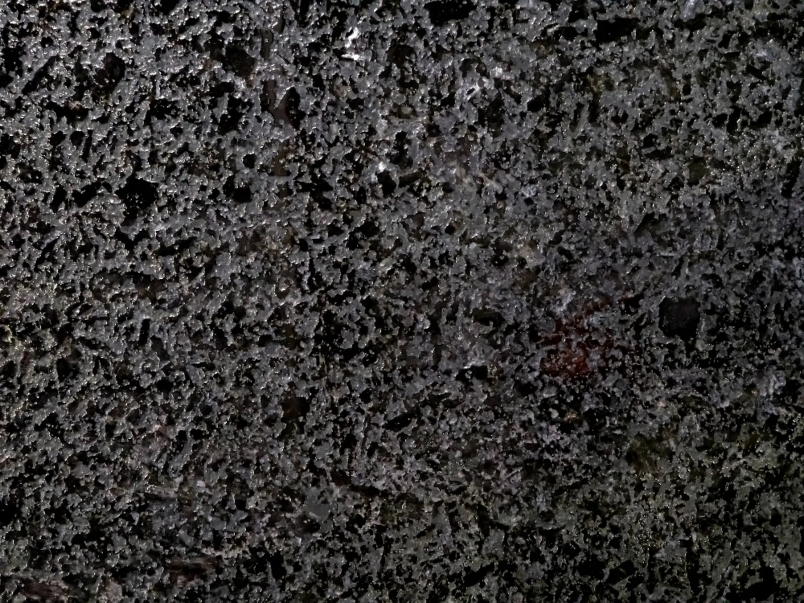 Closeup image of Black Pearl Iced Black Granite countertop slab