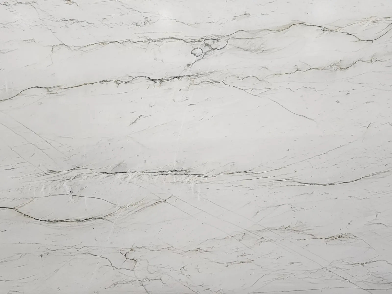 Closeup image of Luce Di Luna White Quartzite countertop slab
