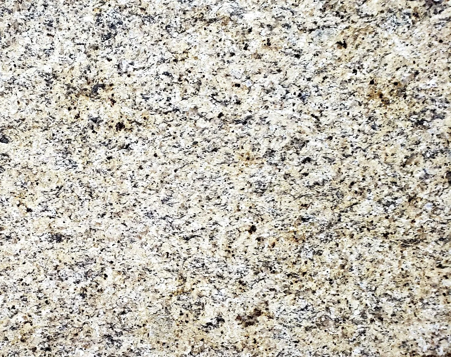 Closeup image of New Venetian Gold Beige Granite countertop slab