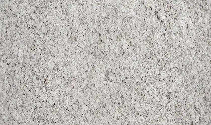Closeup image of Ornamental Guidoni Cream Granite countertop slab