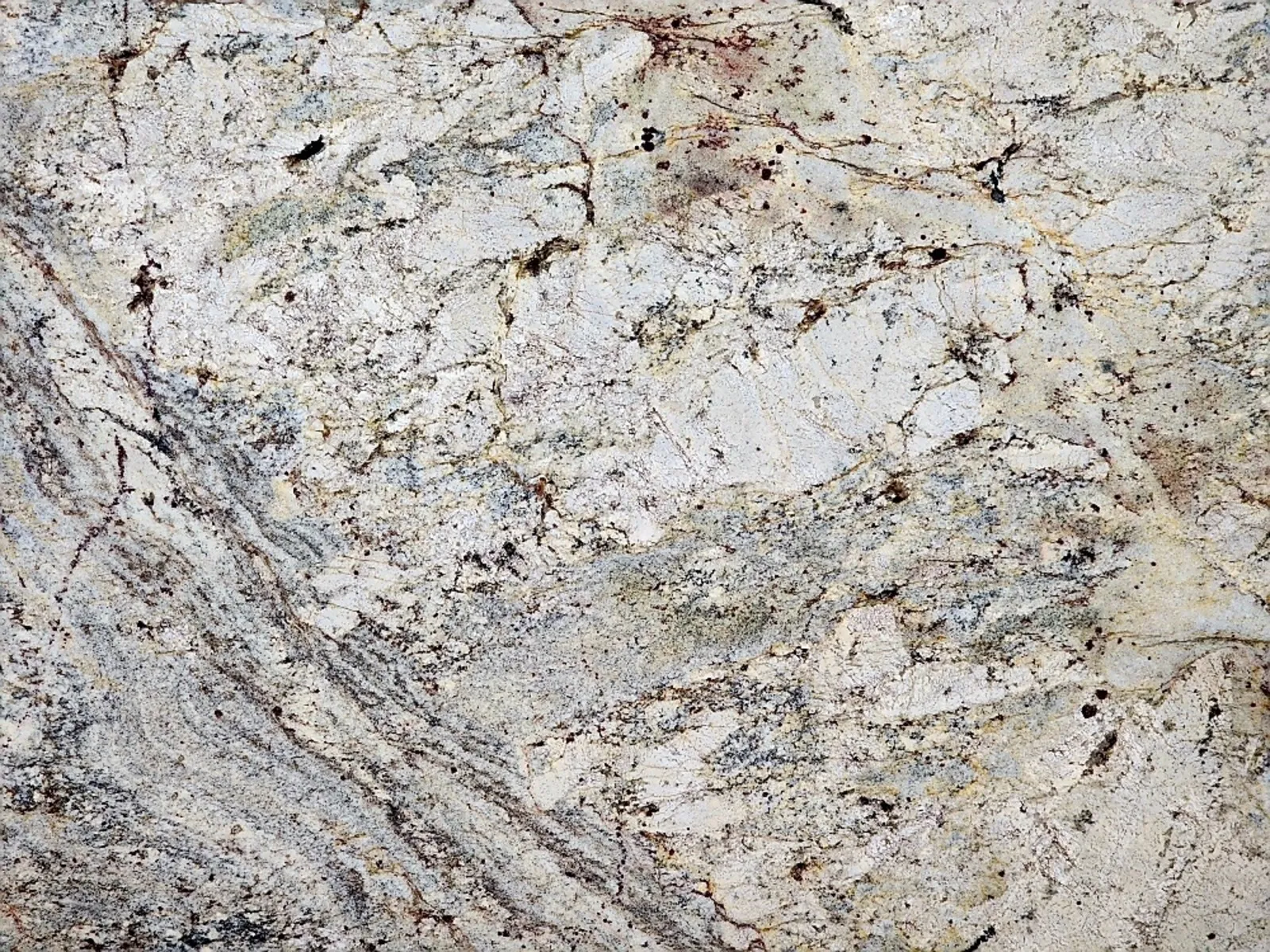 Closeup image of Typhoon Bordeaux Cream Granite countertop slab