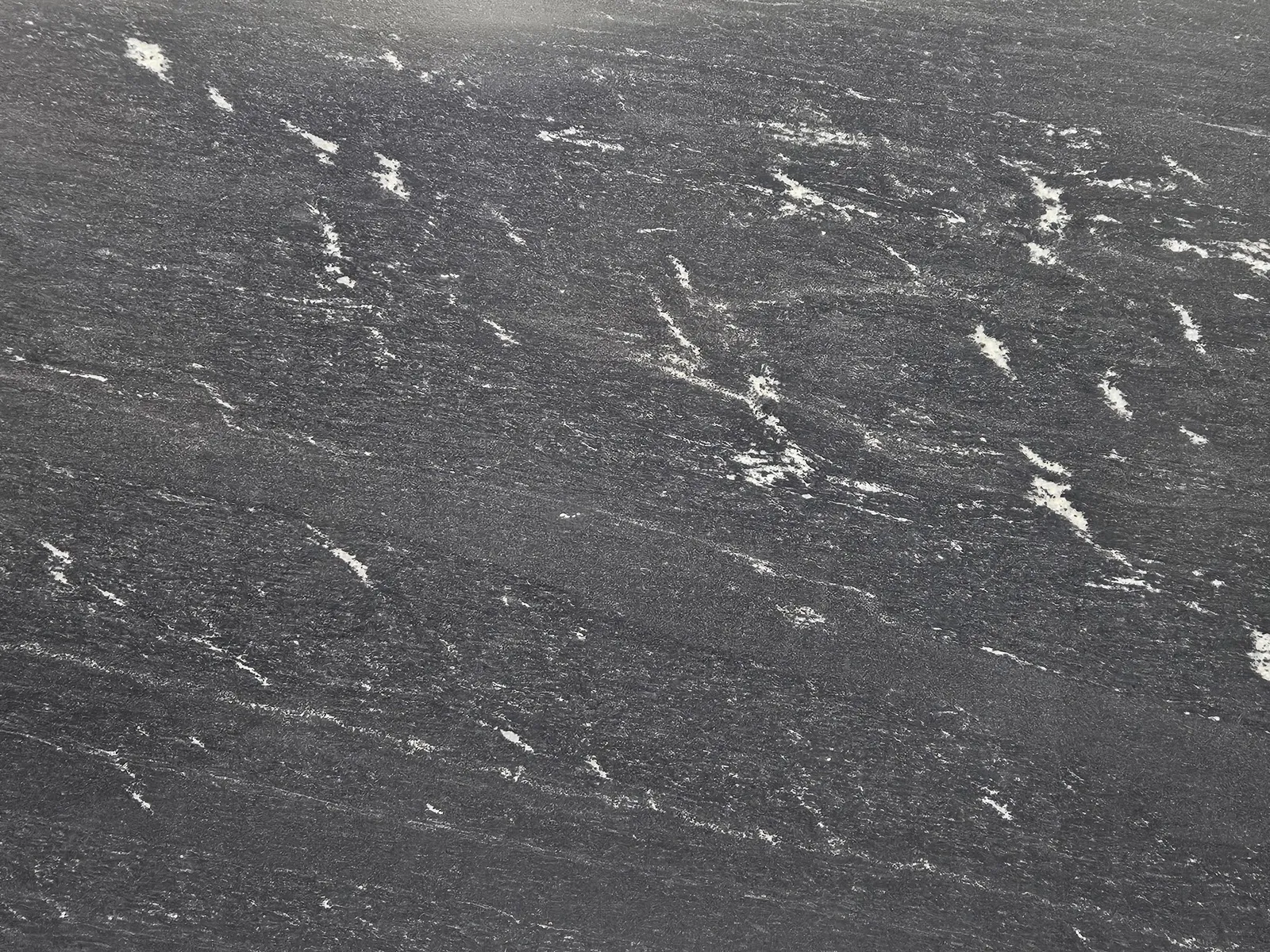 Closeup image of Via Lactea Grey Granite countertop slab