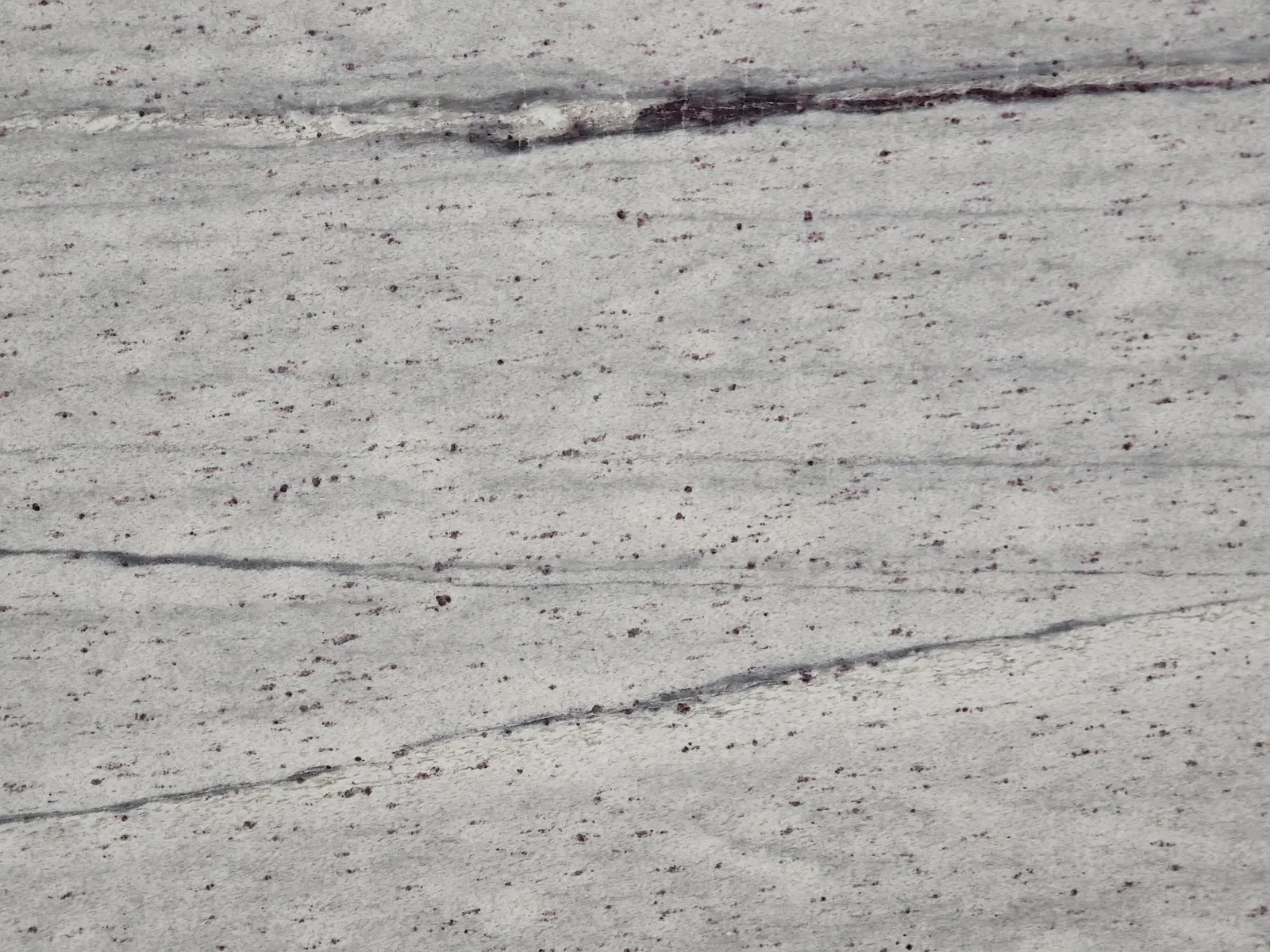 Closeup image of River White Grey Granite countertop slab