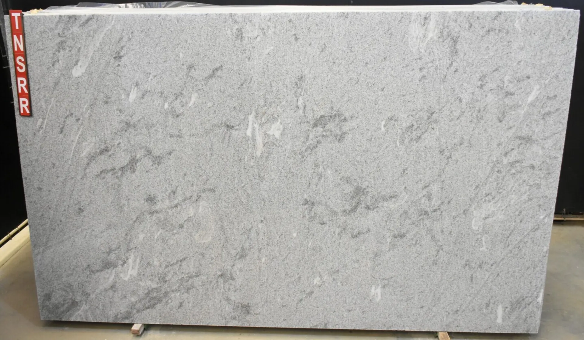 Closeup image of White Alpha 1st Choice Grey Granite countertop slab