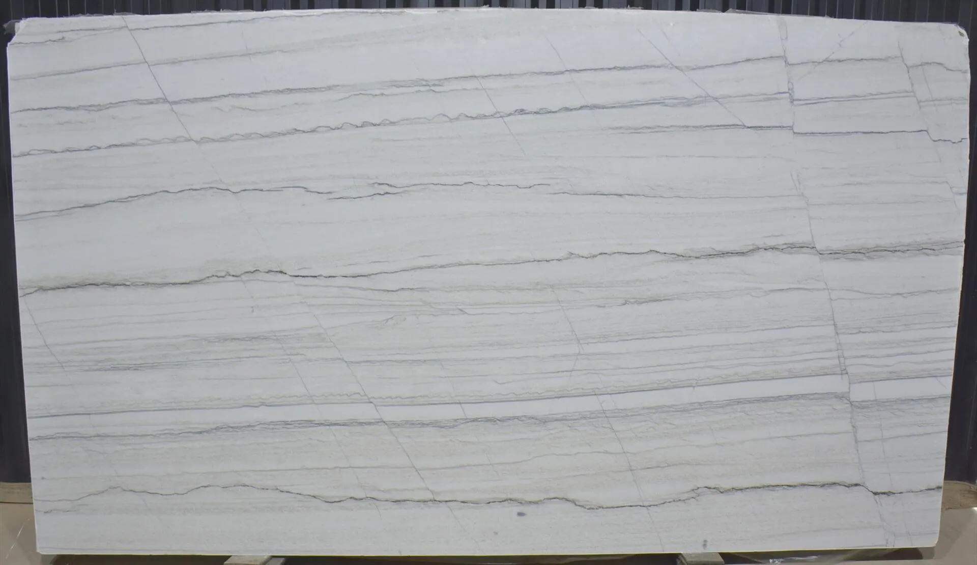 Closeup image of White Macaubas White Quartzite countertop slab