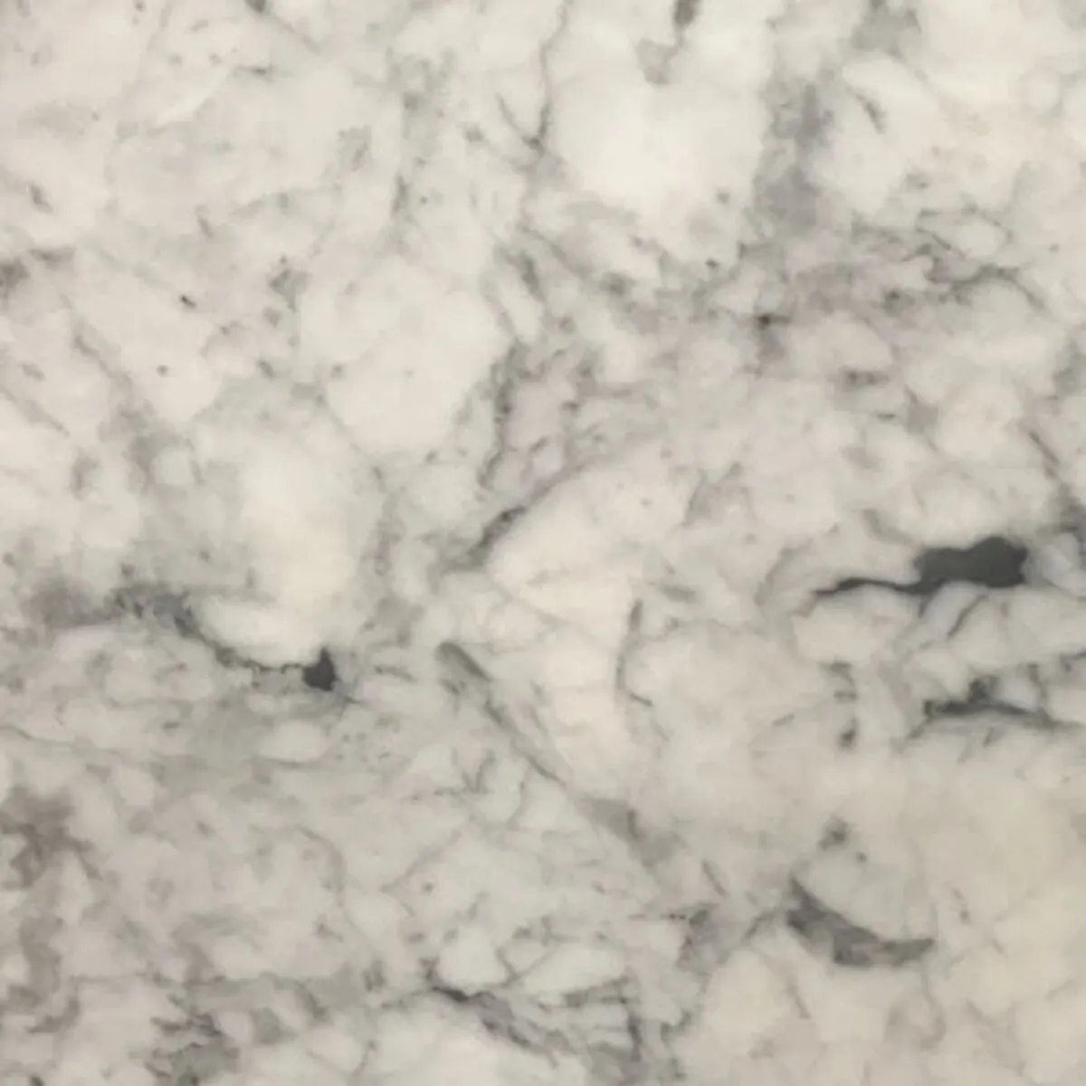 Closeup image of White Carrara White Marble countertop slab