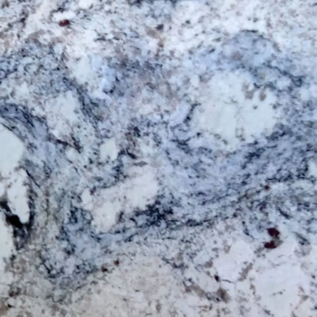 Closeup image of White Ice Grey Granite countertop slab