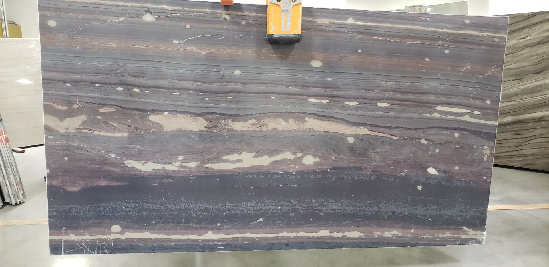 Closeup image of Marron Bamboo Purple Granite countertop slab