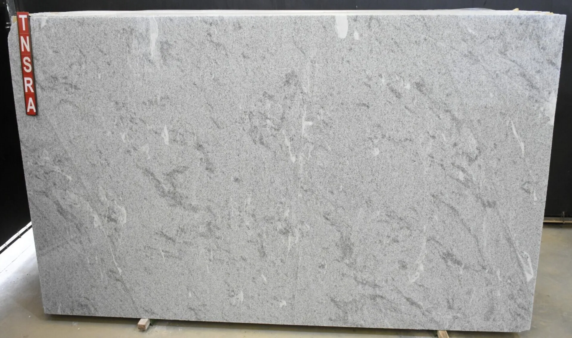 Closeup image of White Alpha 1st Choice Grey Granite countertop slab