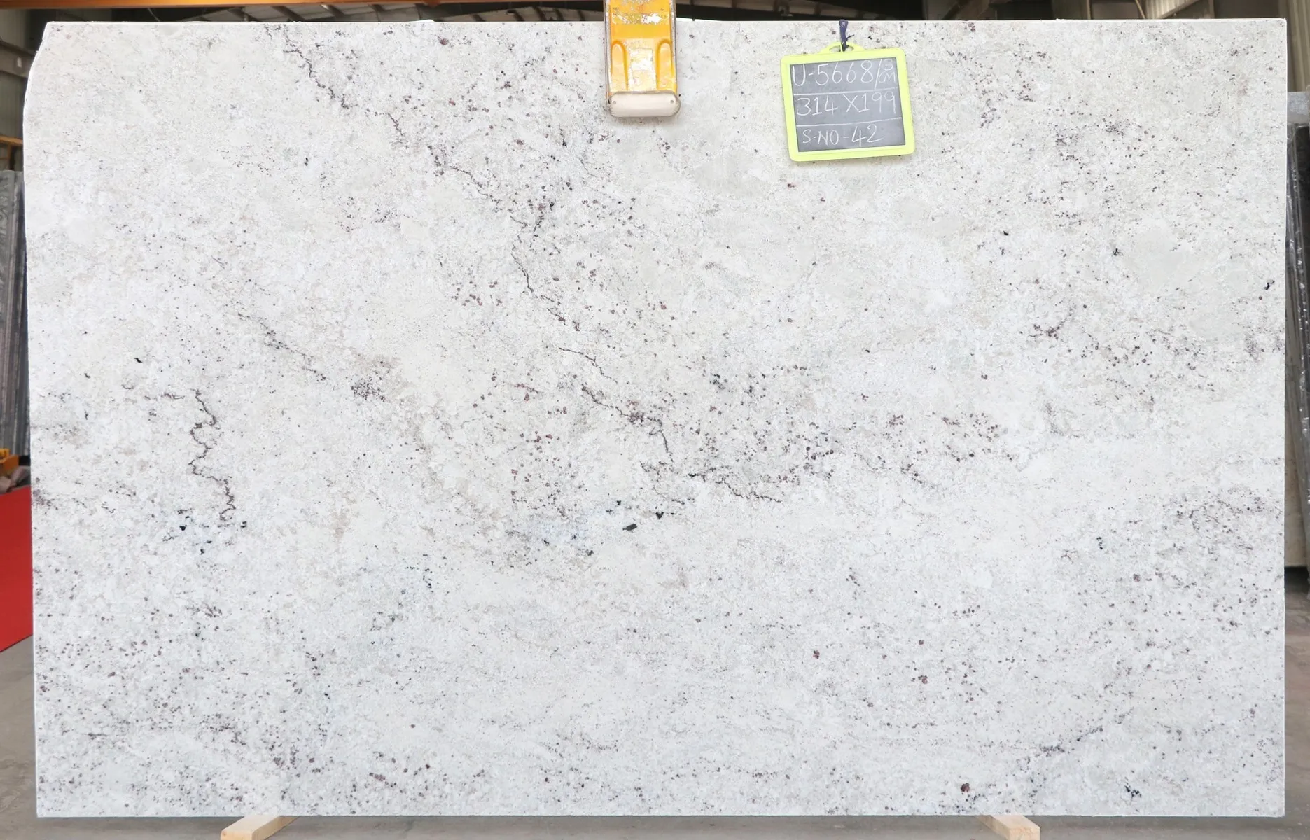 Closeup image of Colonial White 1st Choice Cream Granite countertop slab