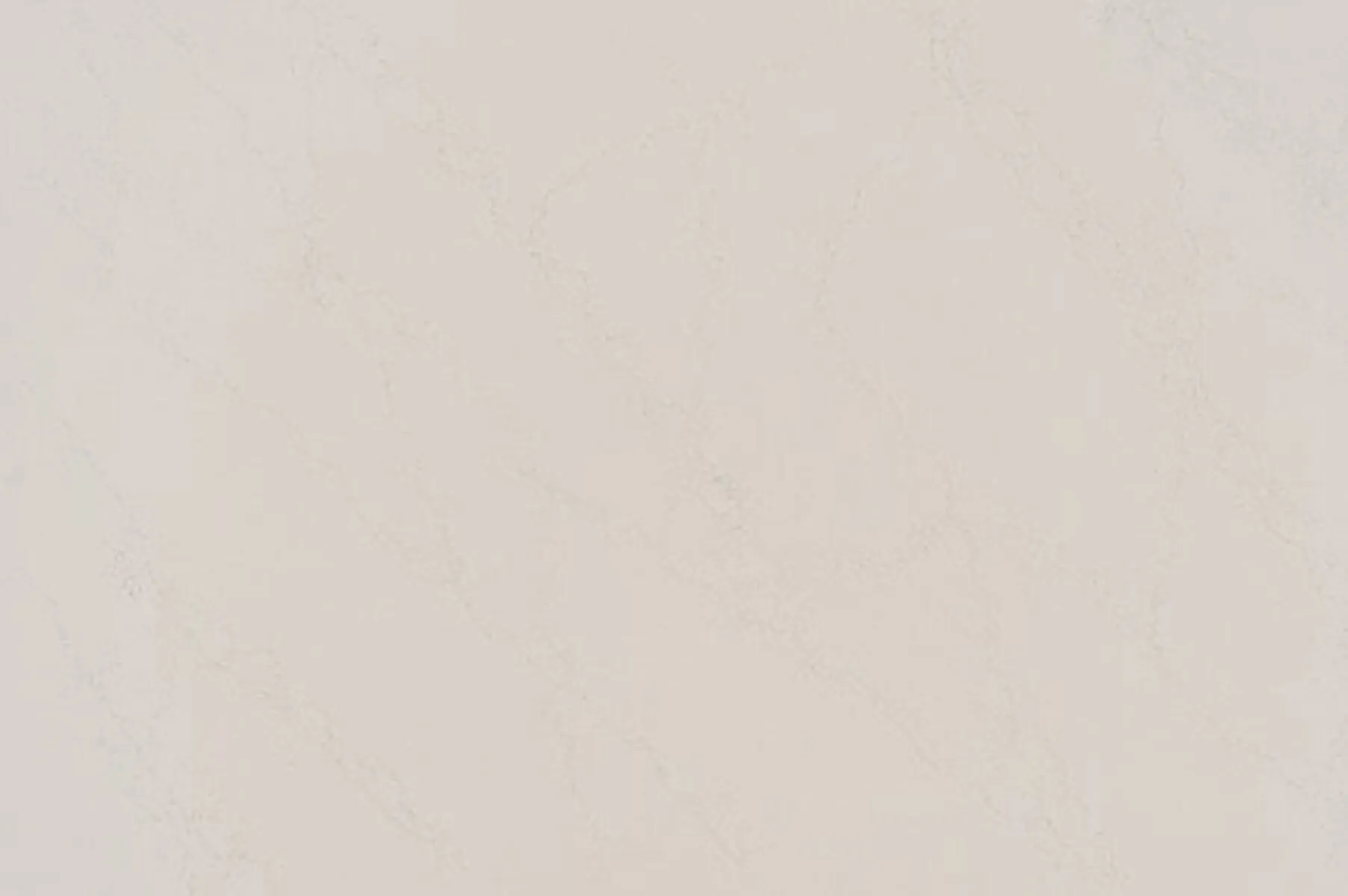 Closeup image of ONE Quartz Surfaces Liberty Calacatta Cream Quartz countertop slab