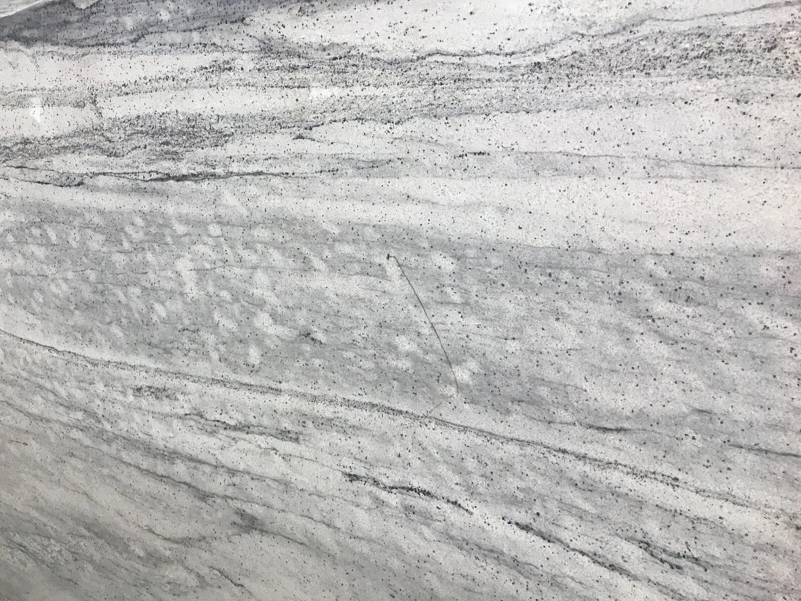 Closeup image of Thunder White Grey Granite countertop slab