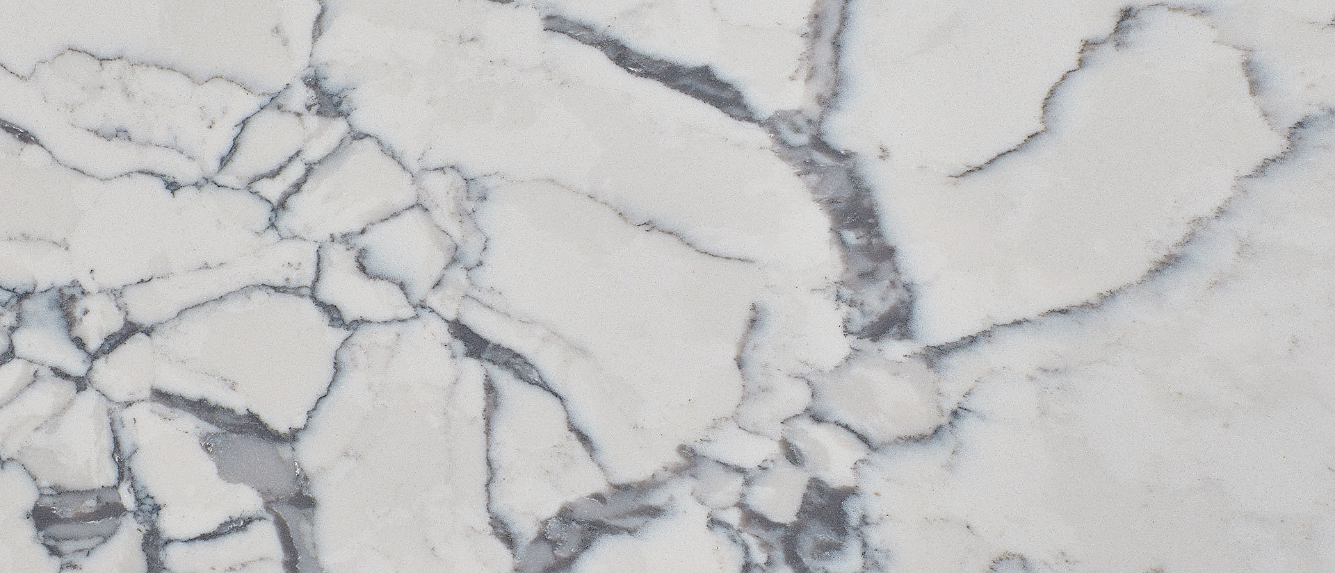 Closeup image of Q Quartz Calacatta Lago Quartz countertop slab