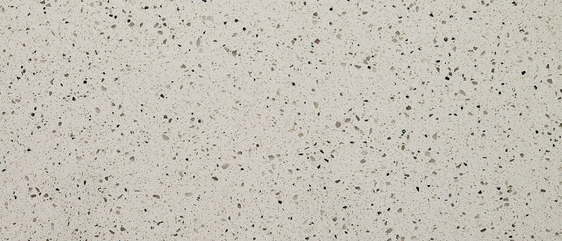 Closeup image of Q Quartz Bianco Pepper Brown Quartz countertop slab