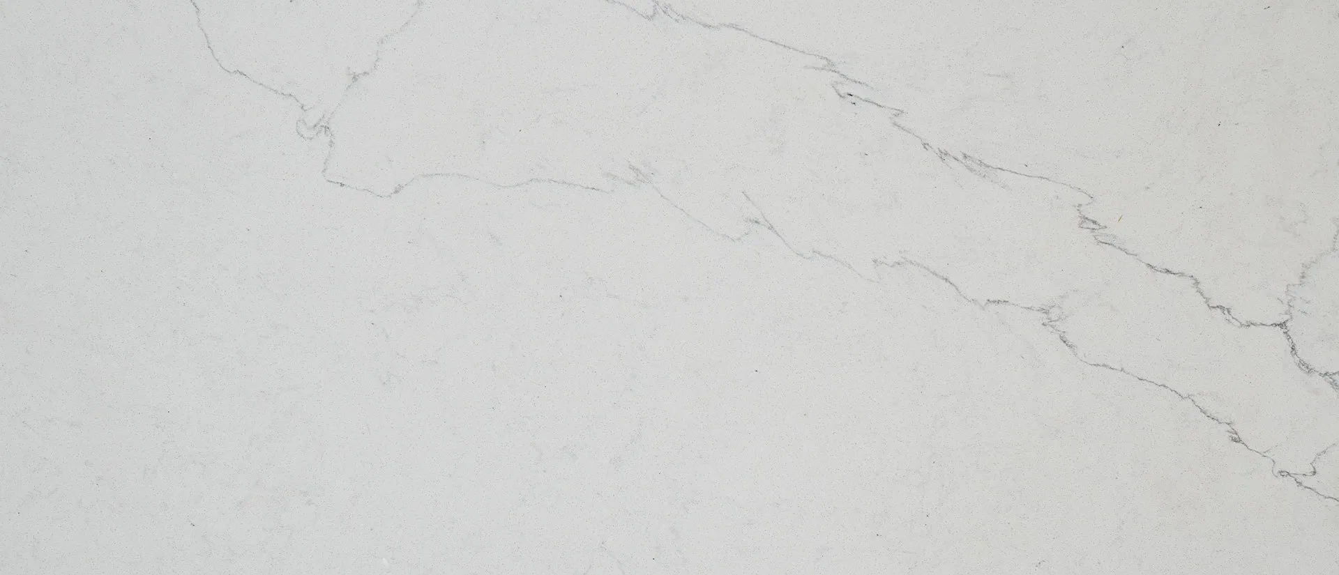 Closeup image of Q Quartz Calacatta Alto Quartz countertop slab