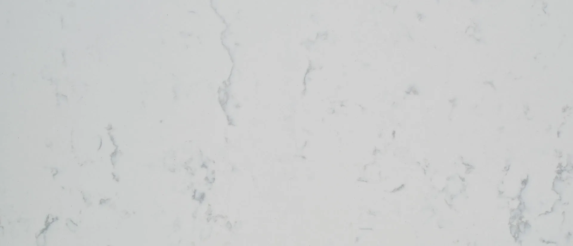 Closeup image of Q Quartz Carrara Lumos White Quartz countertop slab
