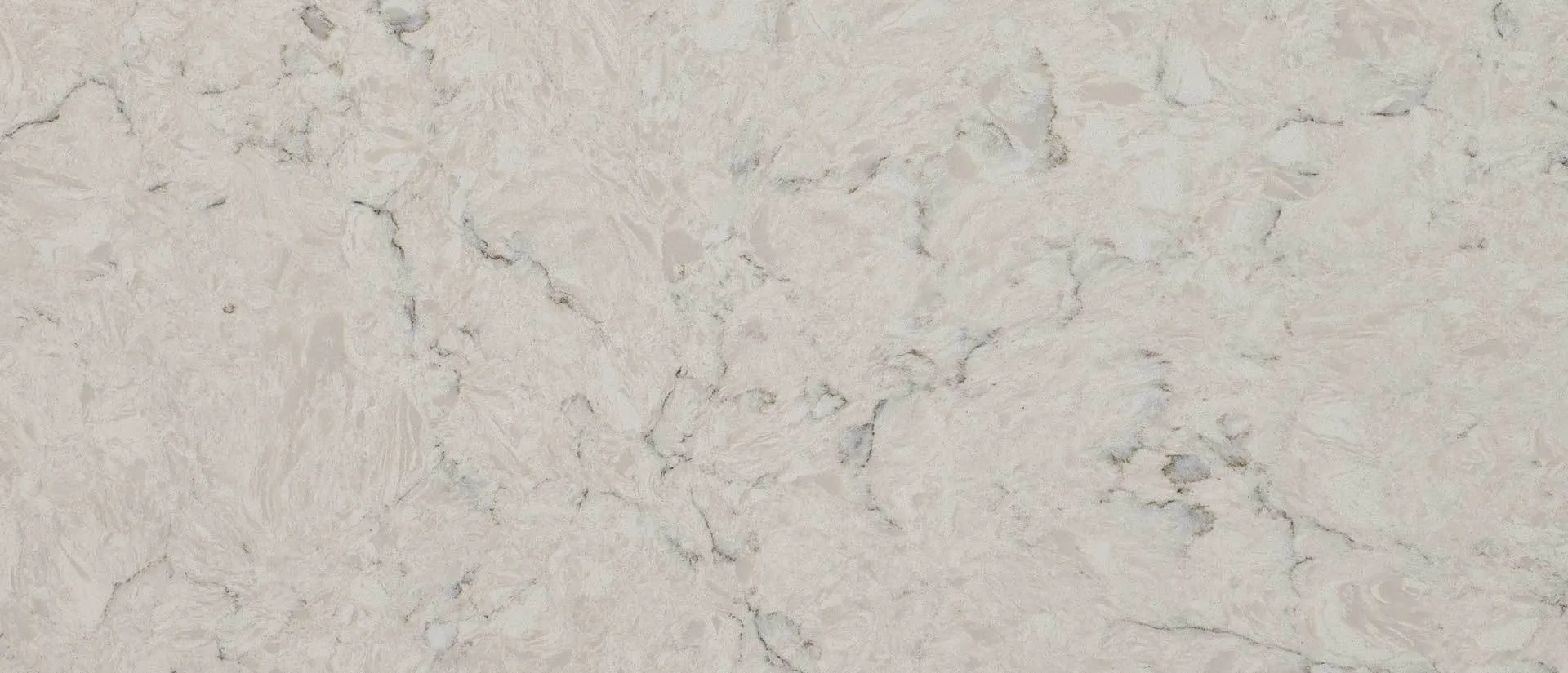 Closeup image of Q Quartz Carrara Mist Cream Quartz countertop slab