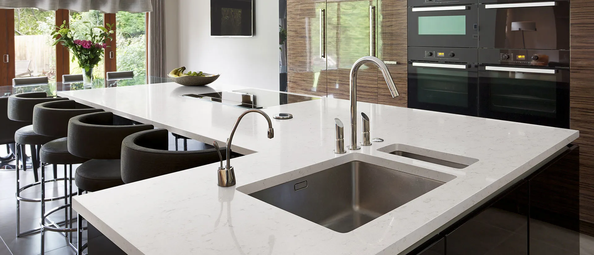 Image of installed Q Quartz New Carrara Marmi Quartz countertops