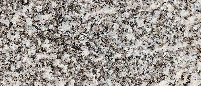 Closeup image of Whisper White Grey Granite countertop slab