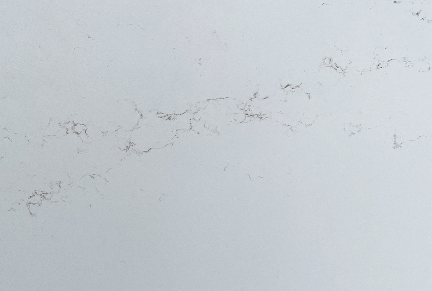Closeup image of CRS Quartz Pluma Oro White Quartz countertop slab