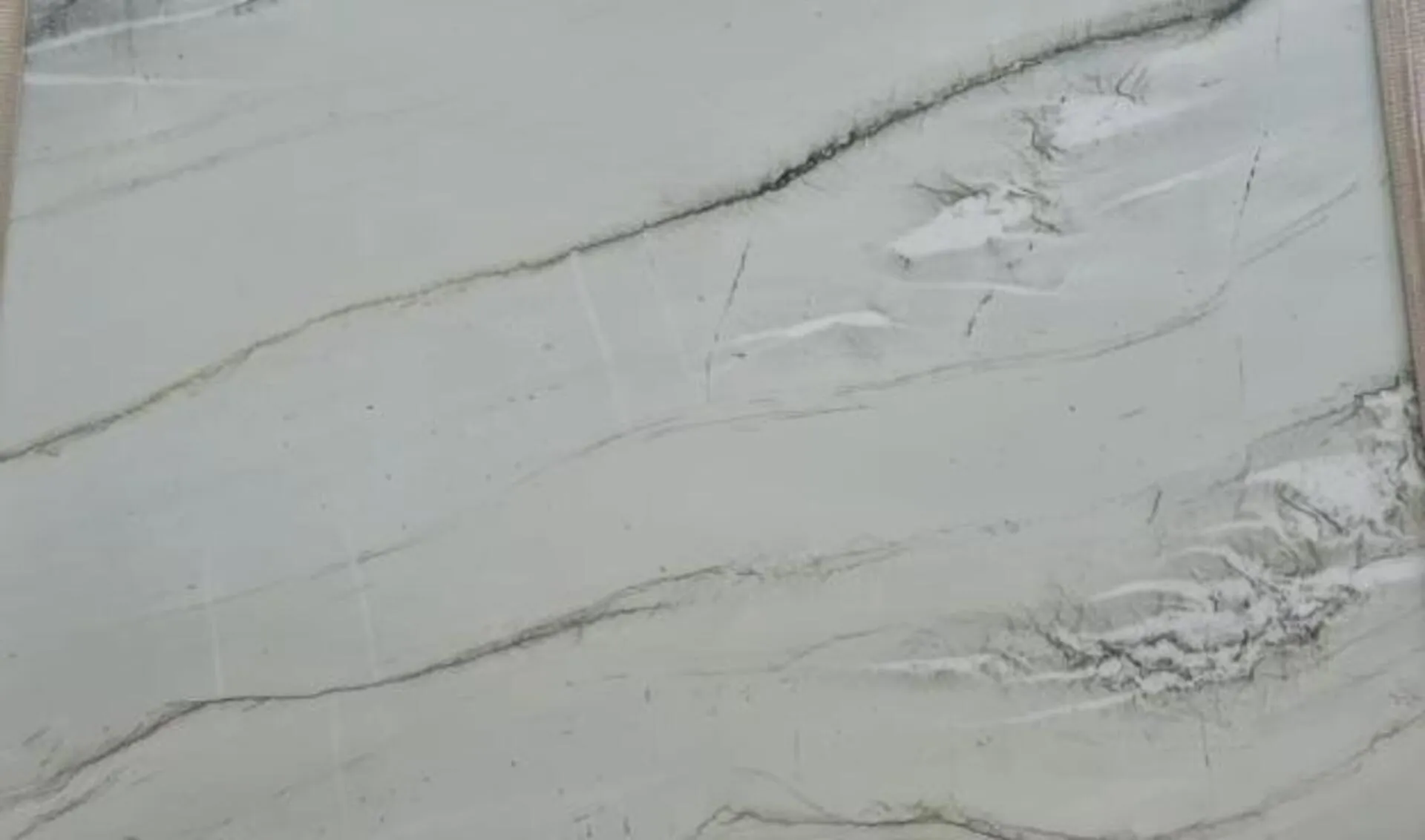 Closeup image of Luce Di Luna White Quartzite countertop slab