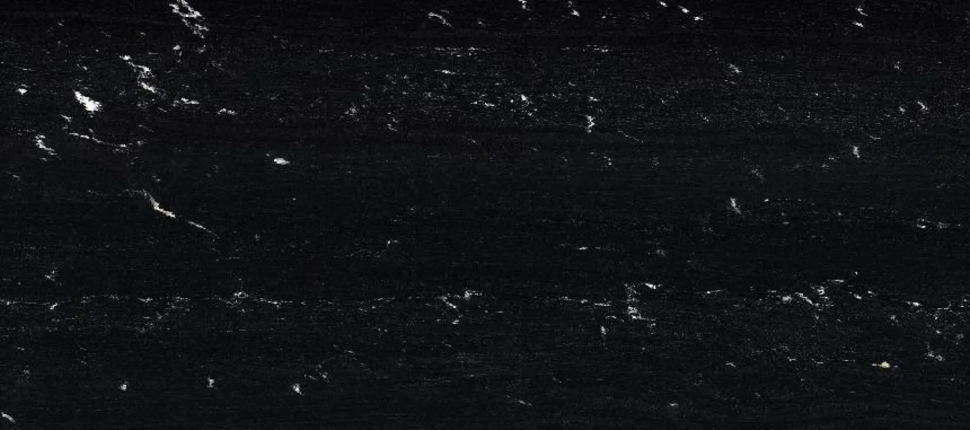 Closeup image of Via Lactea Polished (Leather) Black Granite countertop slab