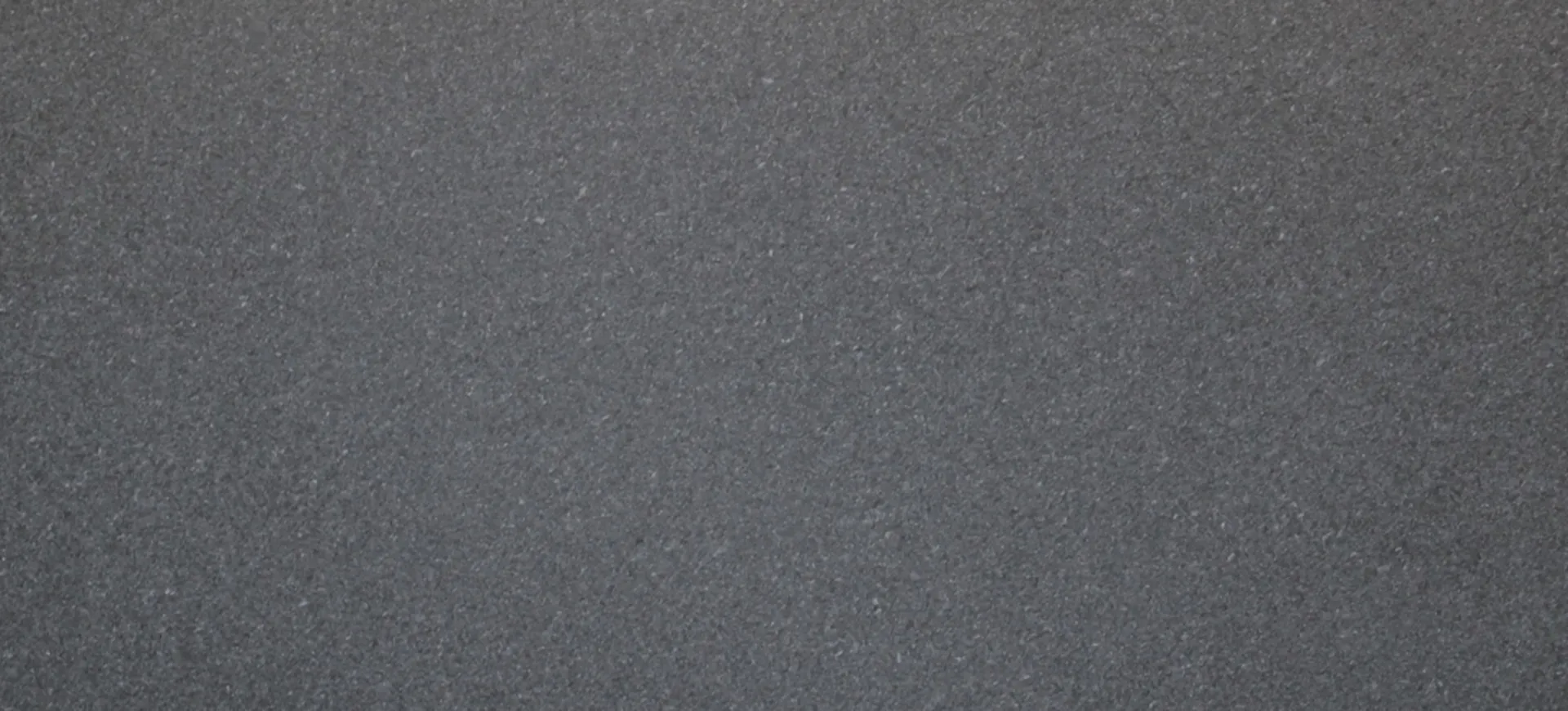 Closeup image of Black Pearl Polished (Leather) Grey Granite countertop slab
